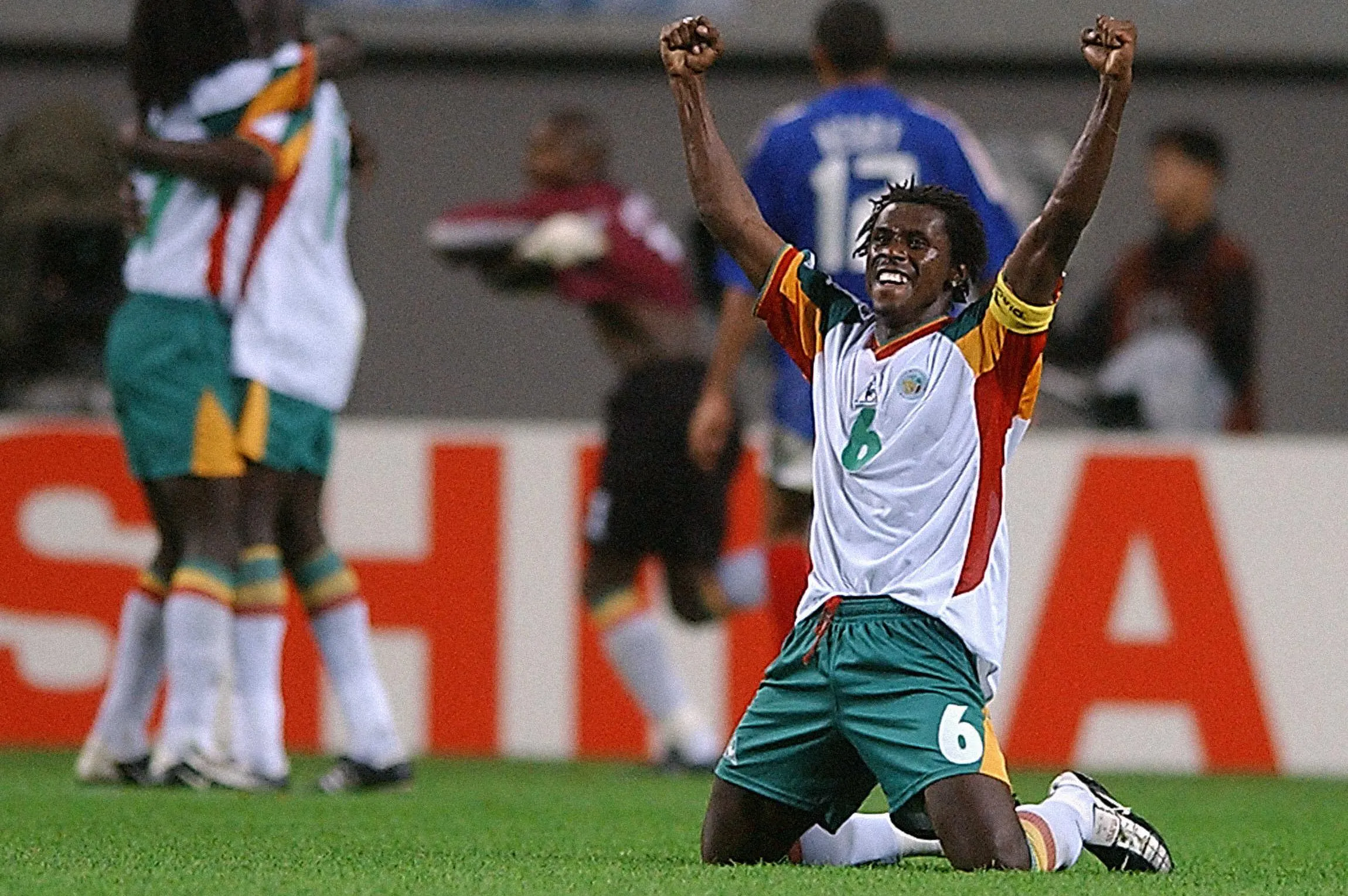 Aliou Cisse on his knees with his arms in the air after Senegal’s win over France in the opening match of 2002 World Cup