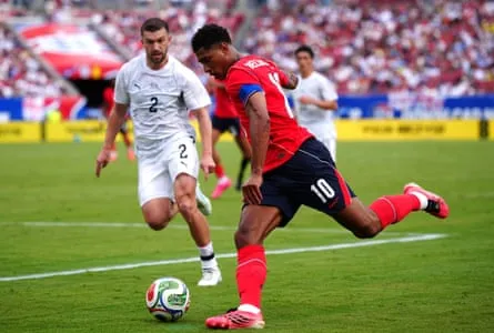 Tim Payne (left) and Jude Bellingham battle for the ball during the friendly between England and New Zealand. Tim Payne (left) and Jude Bellingham battle for the ball during the friendly between England and New Zealand.