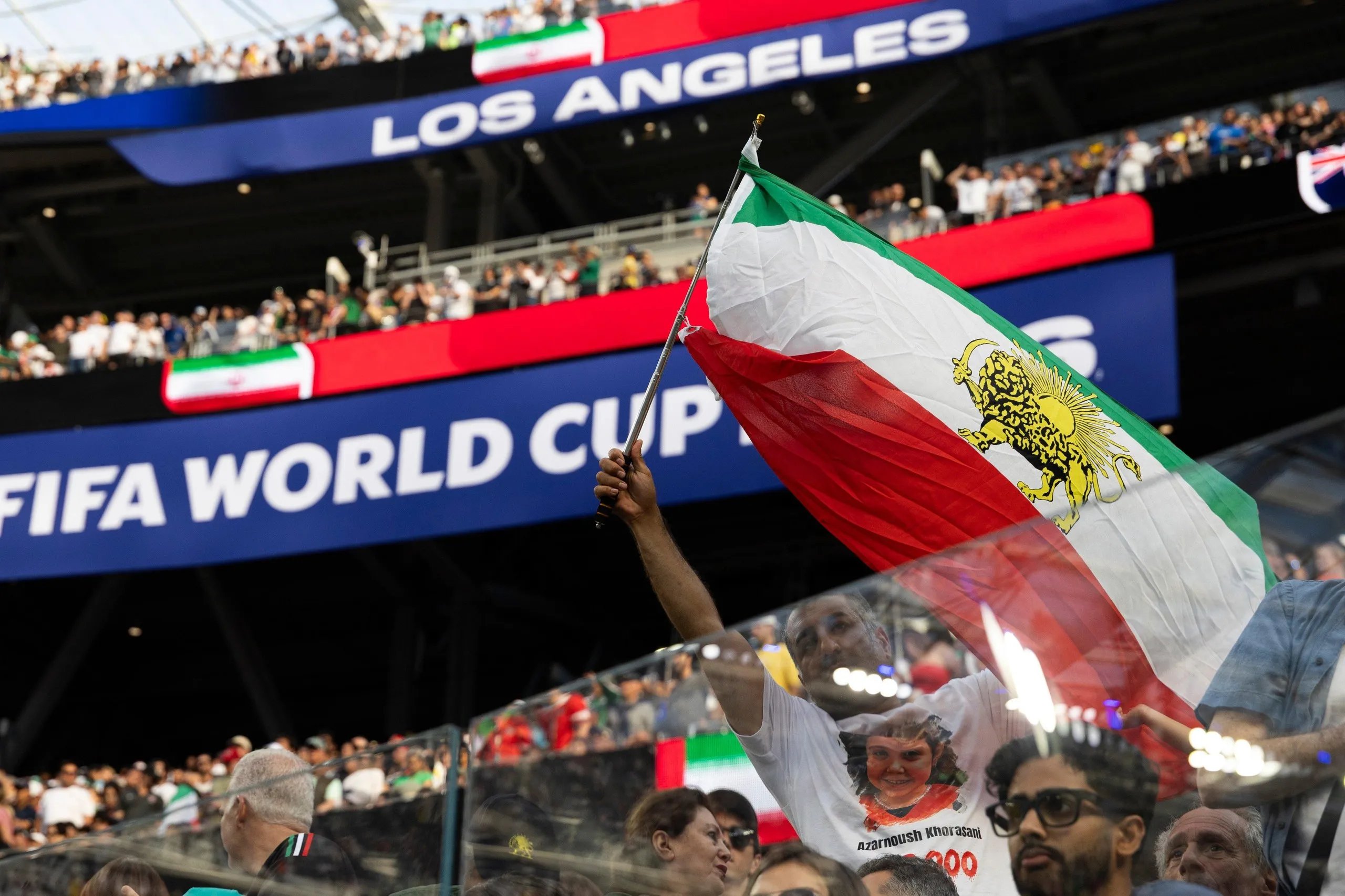 An Iran fan shows pre-revolution Lion and Sun flag during the game against New Zealand at Los Angeles Stadium