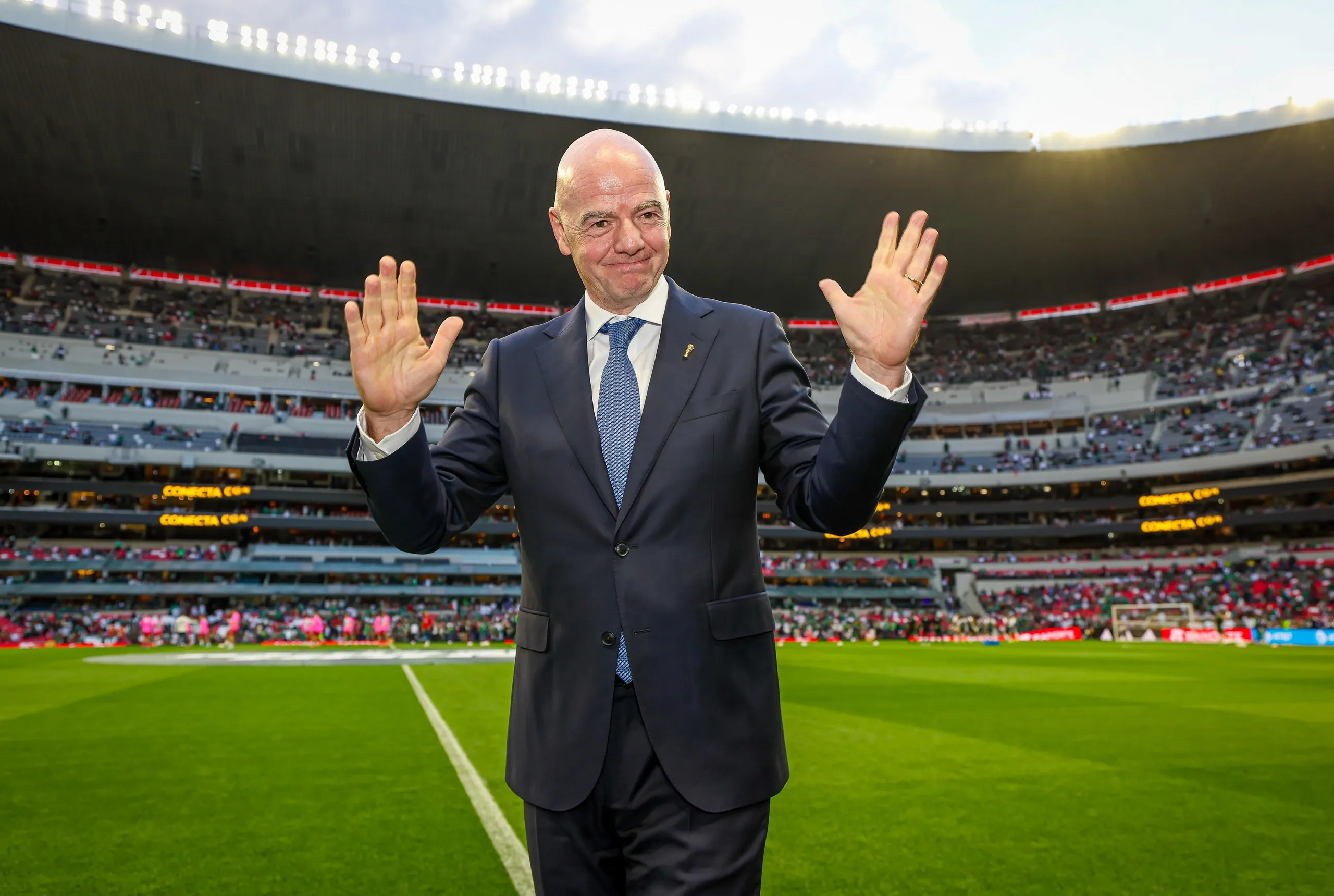 Gianni Infantino waves to watching cameras